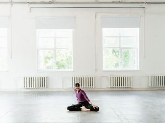 An empty studio room with tall windows